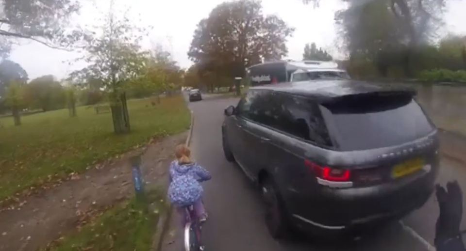 The driver almost hit the young girl as she pedaled along the side of the road