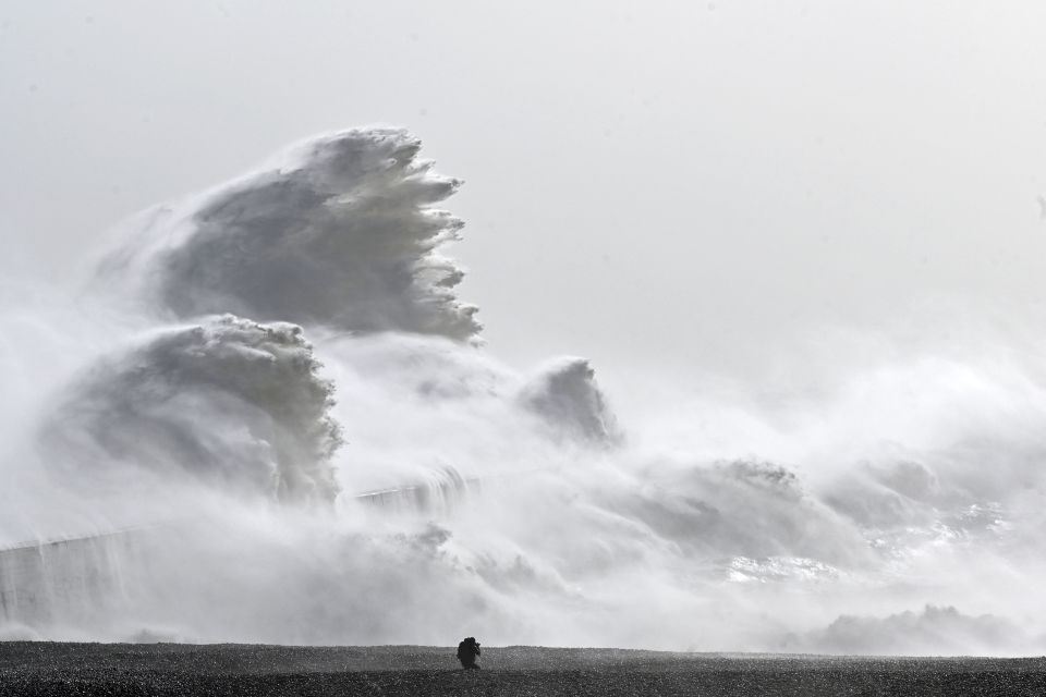 Stunning photos show waves crashing over a sea wall in Newhaven, East Sussex