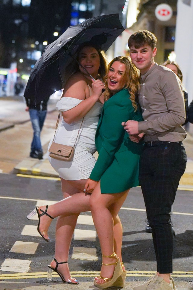 A girl in a pretty white sundress made one concession to accommodate the poor weather, taking an umbrella along for the evening