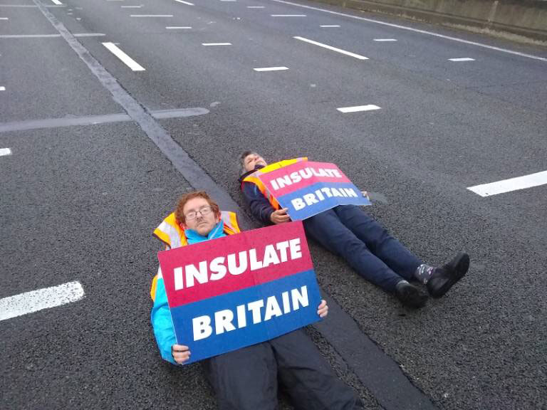 Two Insulate Britain protesters, not necessarily those charged, in action