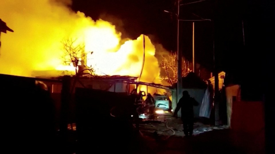 Flames from a burning home light up the night