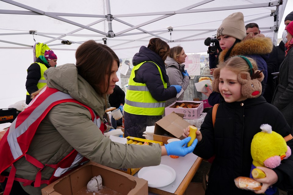 Roxolana Scherbinska, eight, receives fruit and cake