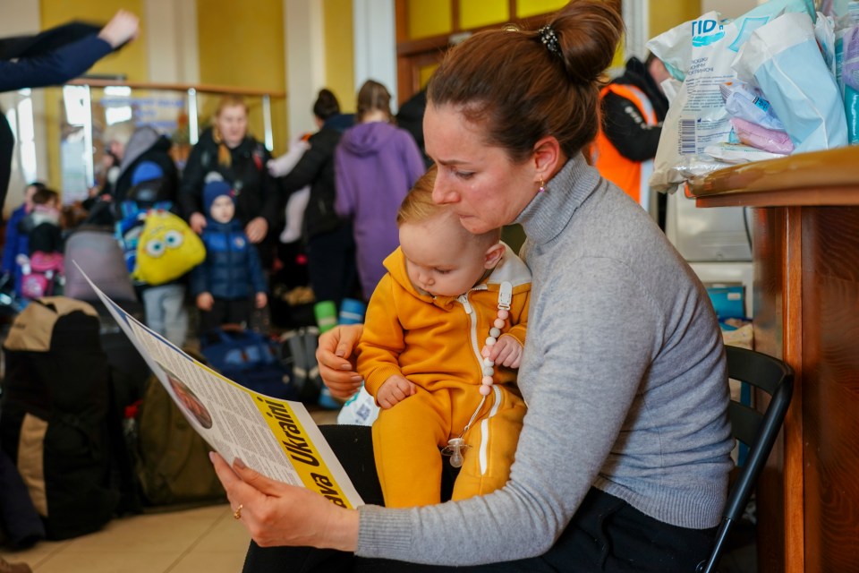 Olga Kapinos, 42, with seven-month-old Dinara is moved to tears reading the messages