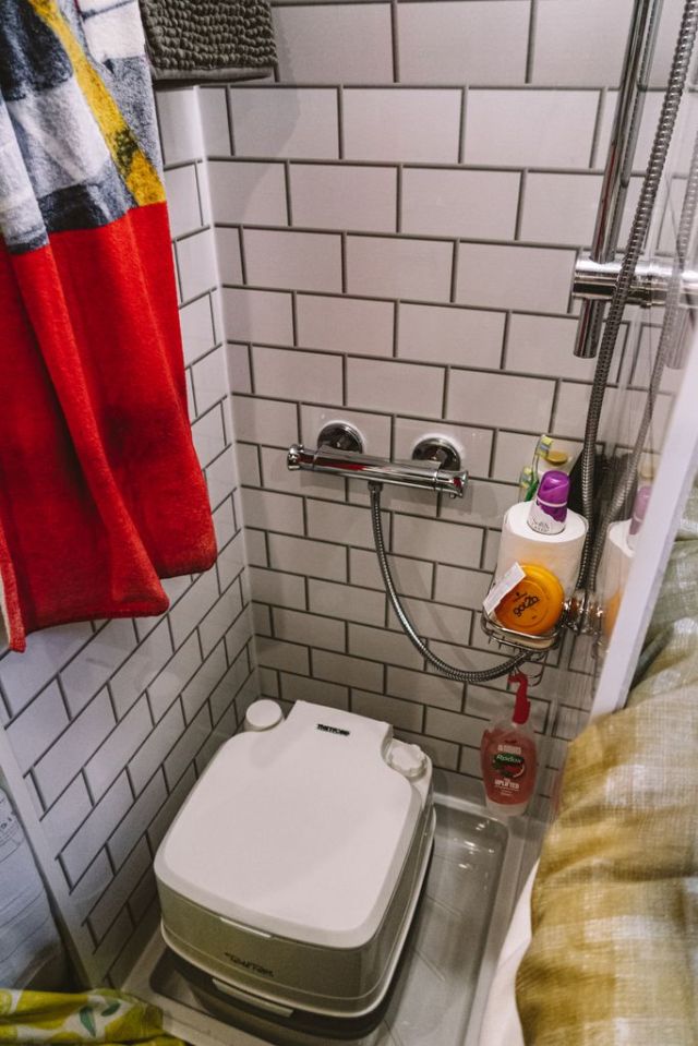 The bathroom contains a shower and a toilet and there's a heating system for hot water