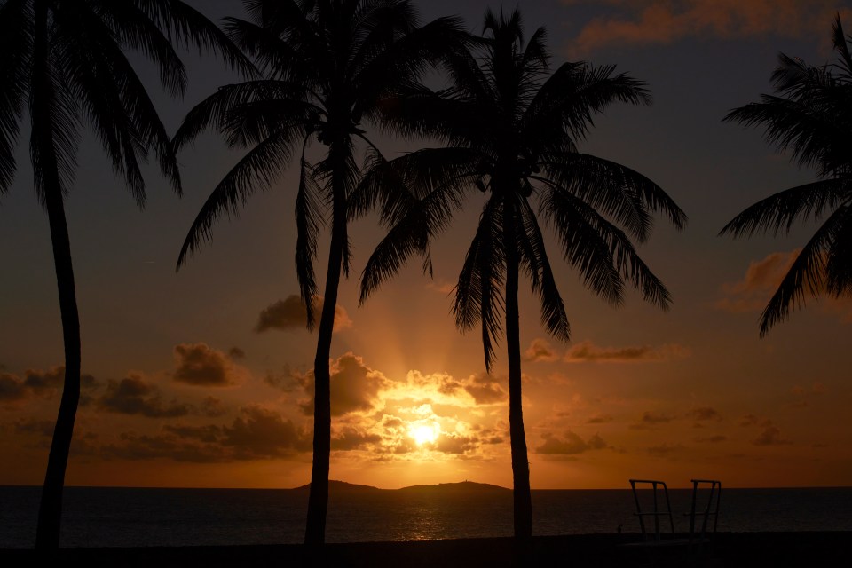 The tropical island in the Caribbean looks out across blue waters and has golden sunsets