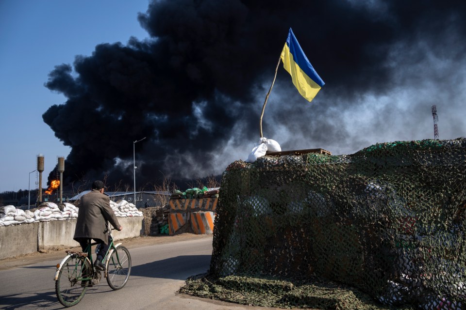 A Ukrainian flag flies defiantly following an attack on the outskirts of Kyiv