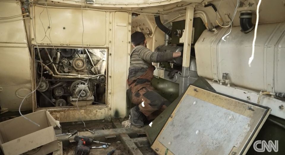 A Ukrainian mechanic working on a captured Russian tank