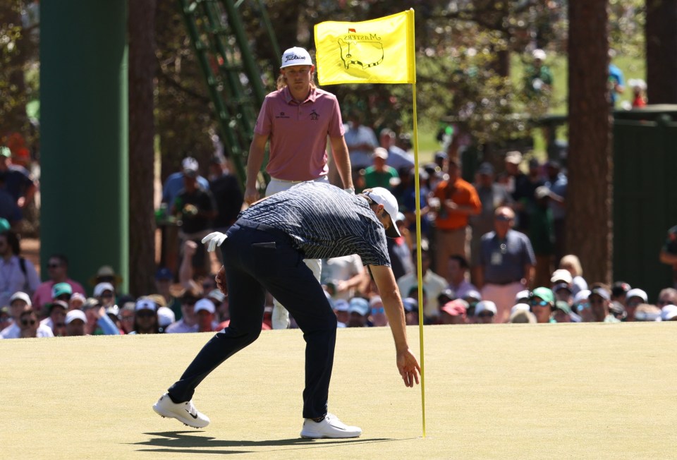 The American retrieves his ball after chipping in on the third - a major turning point