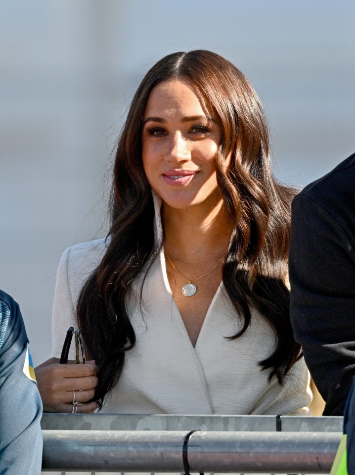 Meghan wore a white jacket and blue jeans for the occasion