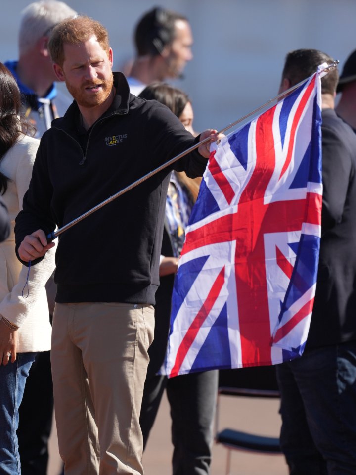 Harry holding a Union Jack, or Union Flag, at the Games