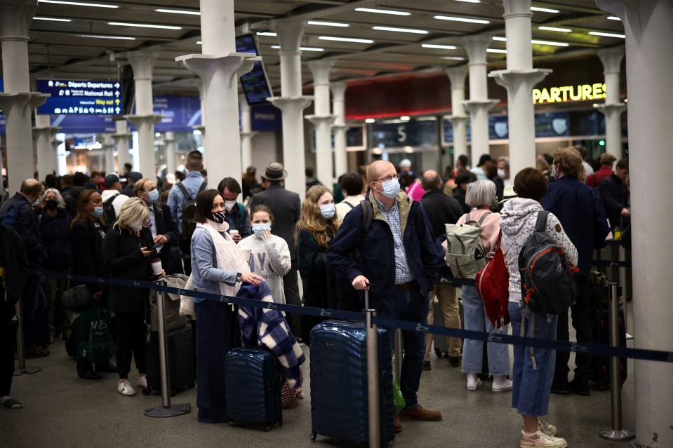 Passengers queue to check in for the Eurostar at St Pancras station in London