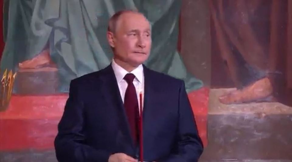 Putin fidgeted and seemed distracted while standing near the altar