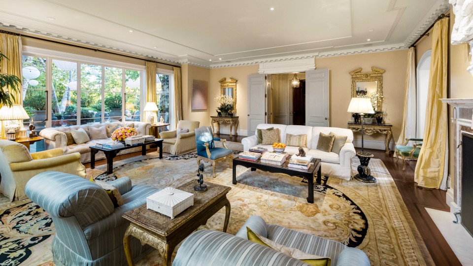 One of the living rooms features huge windows and a modern fireplace