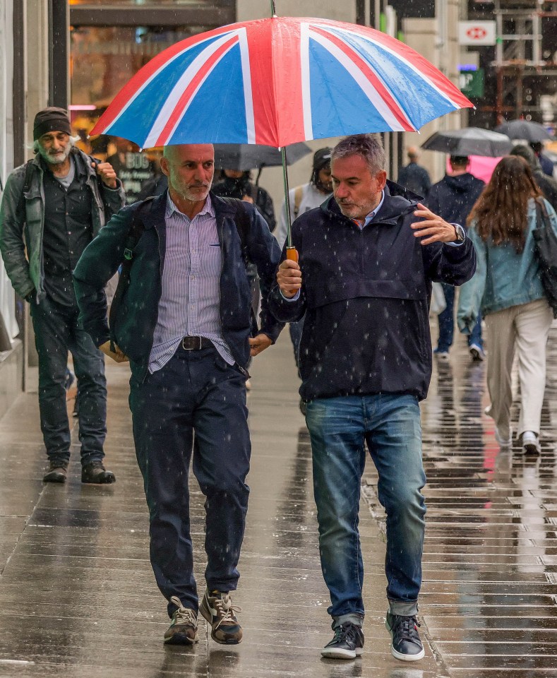 Shoppers and tourists braved the rain at Oxford Circus in London today