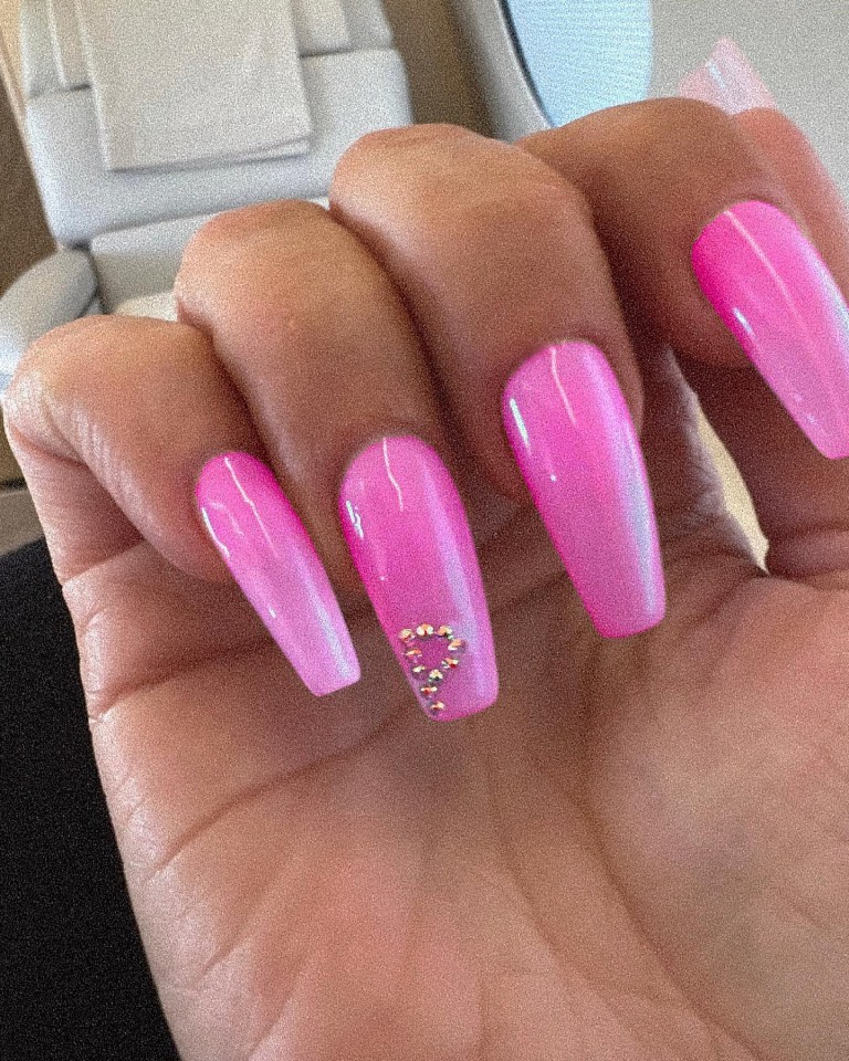 She revealed her pink nails, with the letter 'P' in crystals