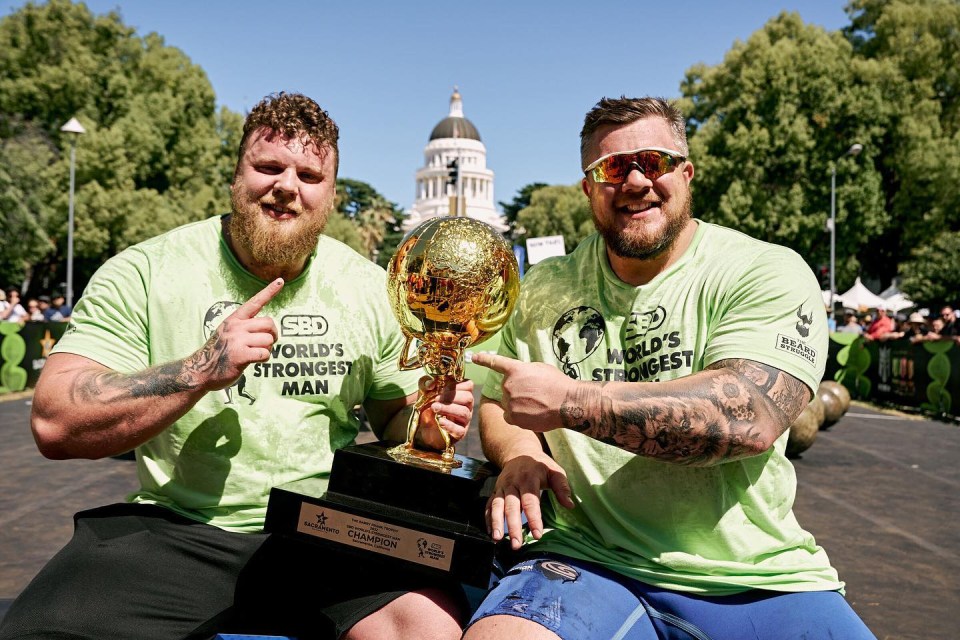 Scottish star Stoltman celebrates with the trophy with older brother and fellow strongman Luke