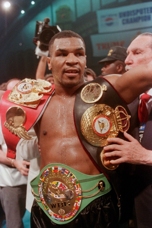 Mike Tyson with his title belts in 1988