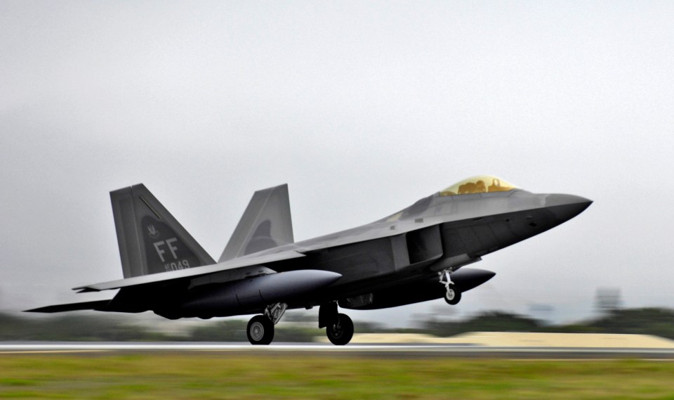 An air force F-22 fighter landing at Kadena Air Base in Japan