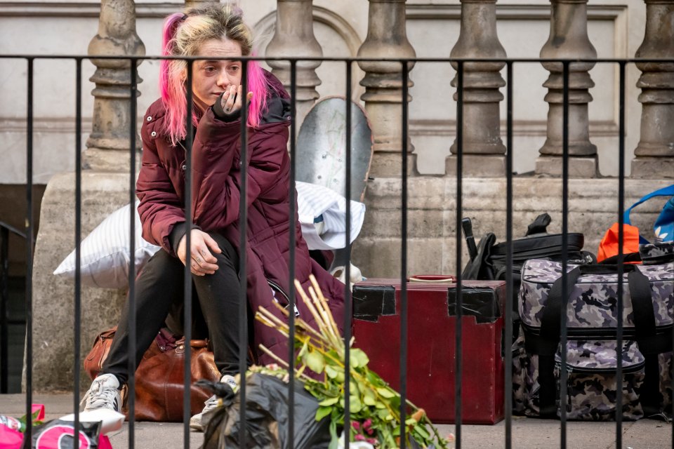 The people who had been living in the house were seen sitting on the street after the eviction