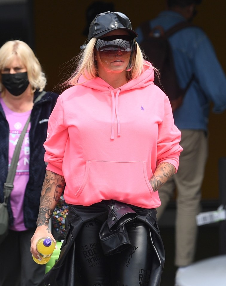 The former glamour model, 44, covered her face with a baseball cap and visor