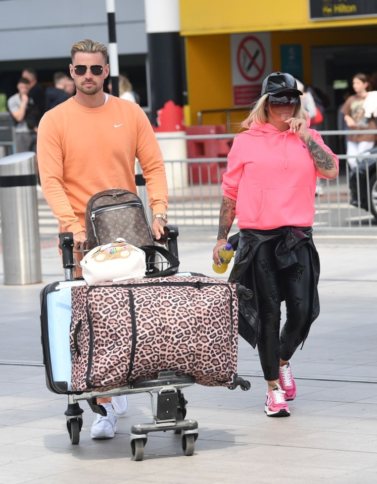 The pair nattered to each other as they made their way through departures