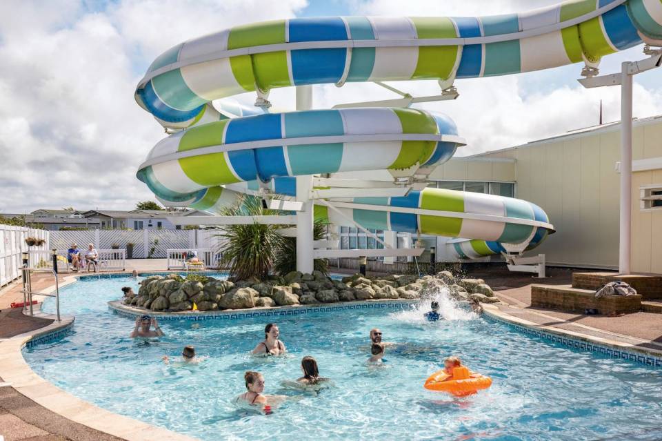 The outdoor pool at Perran Sands park features a water slide too