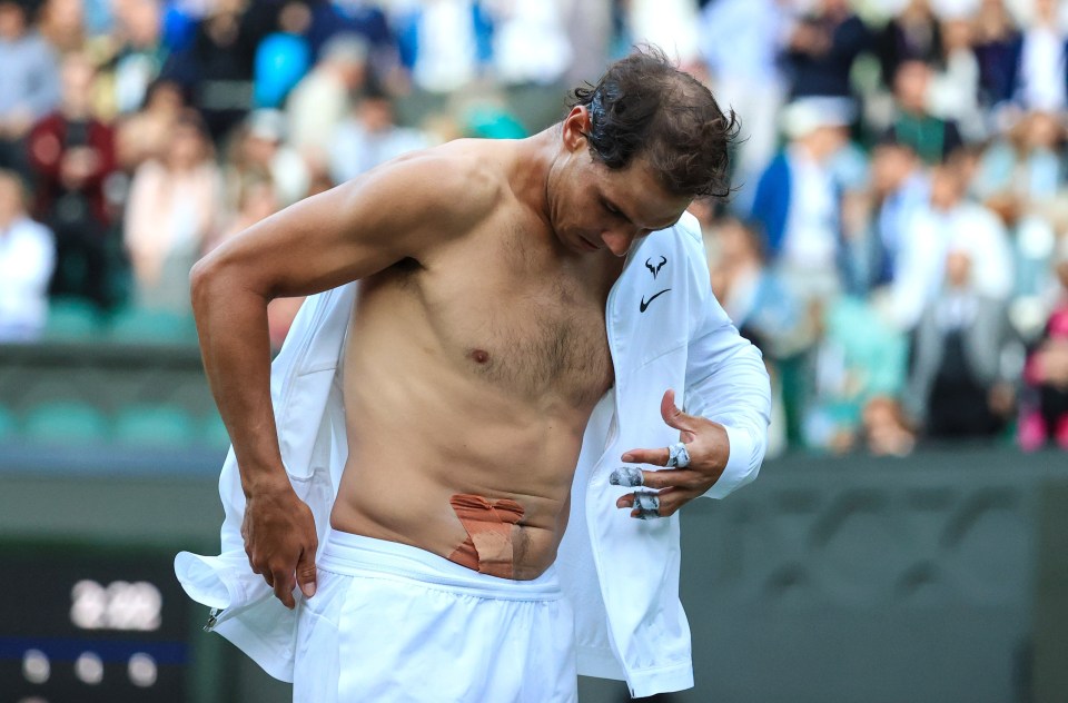 Nadal showed off strapping on his stomach in the SW19 clash