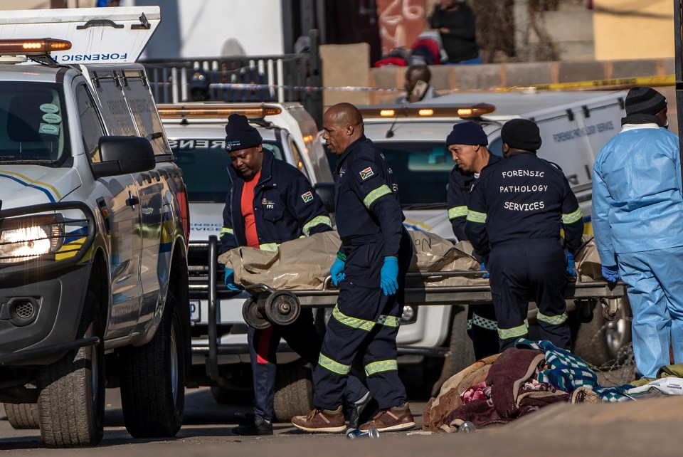 A body is removed from the scene of the shooting in Soweto