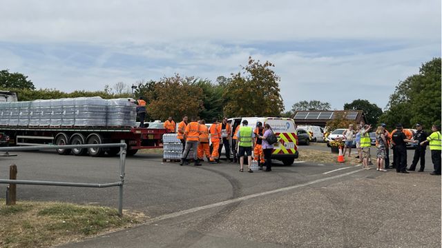 Locals helped hand out water bottles as companies warned Brits of further supply disruption