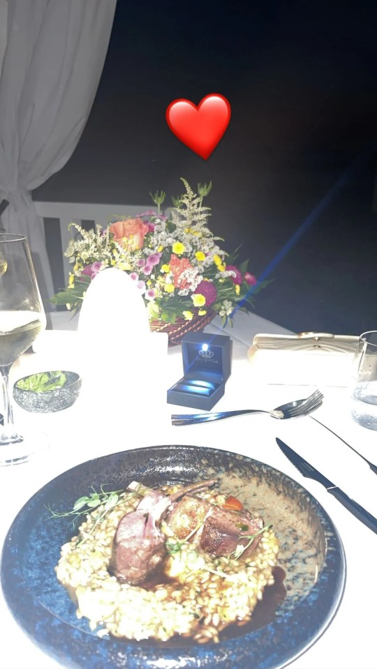 An empty ring box also sat on the table in a photo shared by Elizabeth