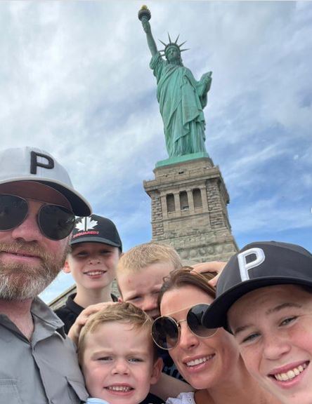 Coleen Rooney was all smiles as she reunited with husband Wayne in the US