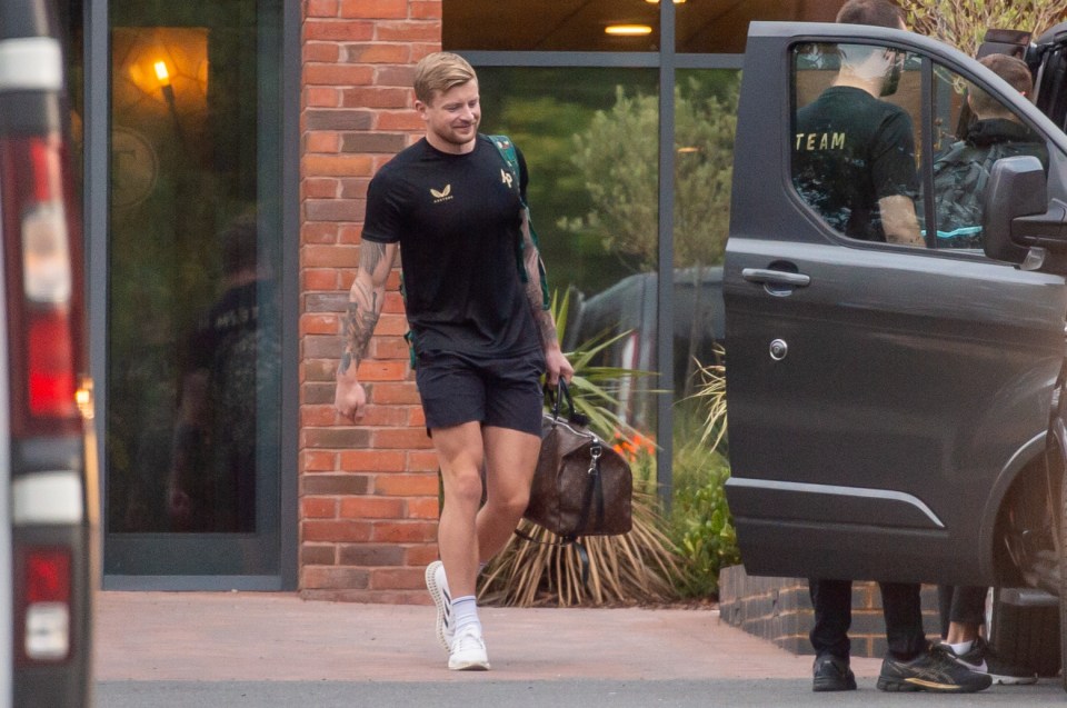 Adam, 27, donned an all black outfit and clutched onto a Louis Vuitton as he left the hotel