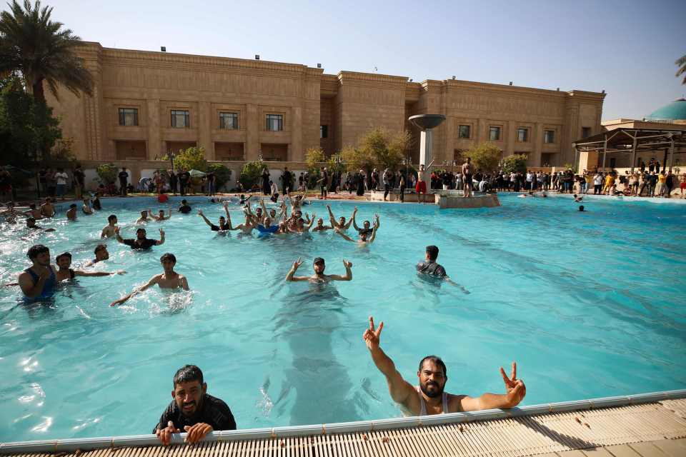 Demonstrators taking a dip in the presidential swimming pool inside the palace