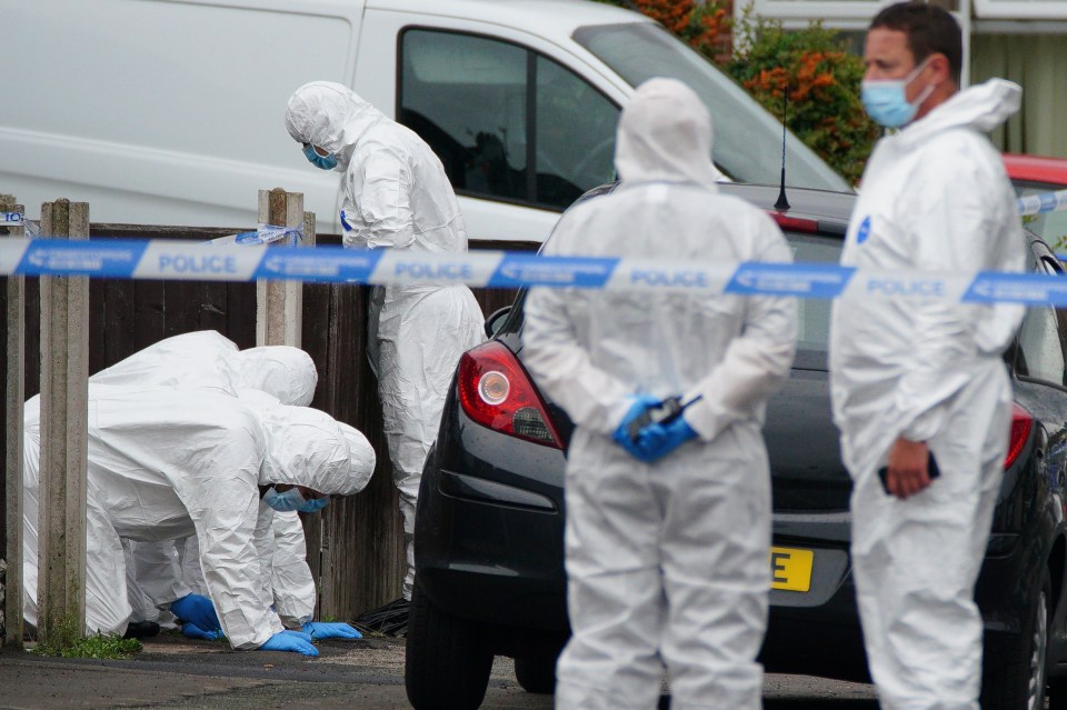The PC used his hand to cover her bullet wound in a bid to save her, pictured: forensics officers at the scene