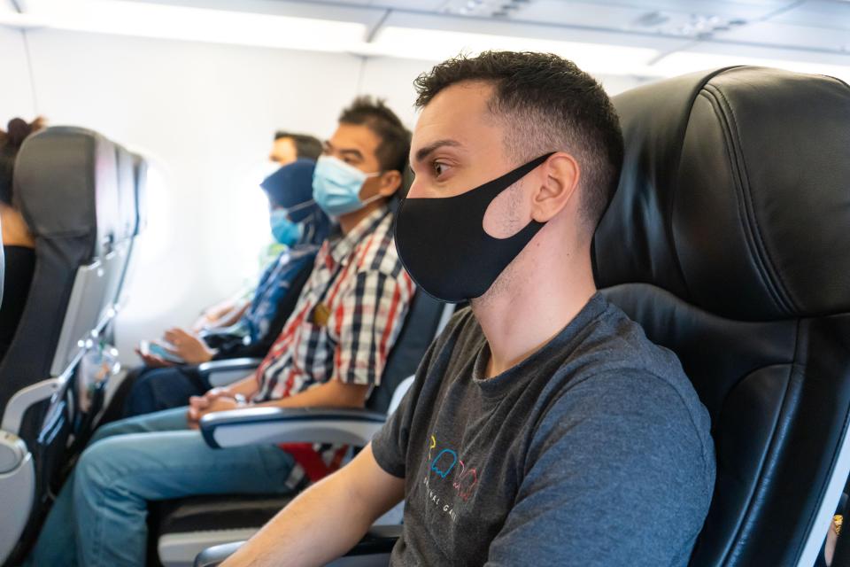 The woman didn't want to recline as she had tall men sat behind her (stock image)