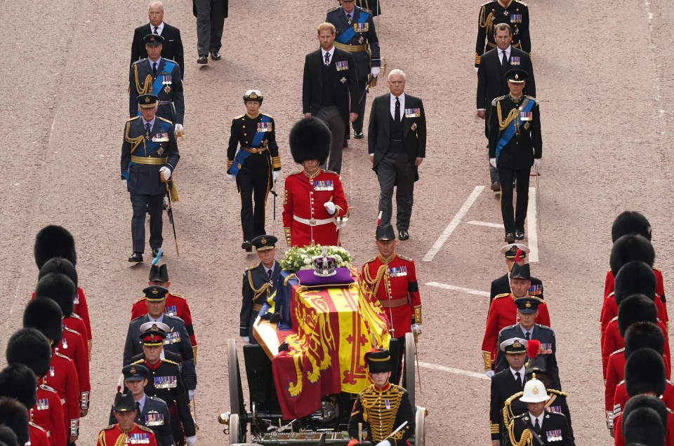 The Royal Family march slowly behind the Queen's coffin