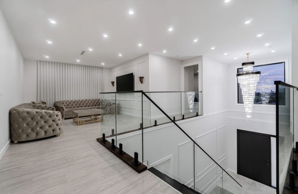 There is a chandelier above the stairs