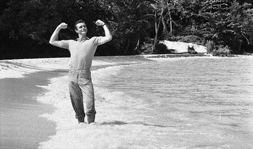 Connery flexes his muscles on the set of Dr. No in 1962