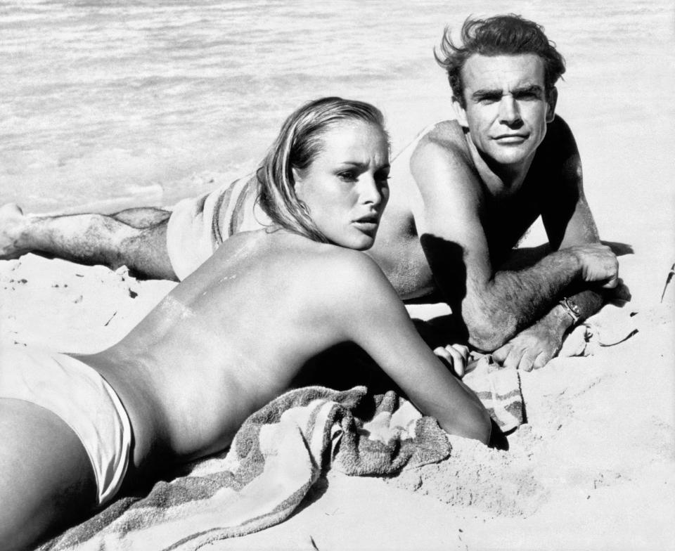 Ursula Andress and Connery lazing on the beach during filming