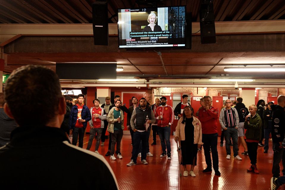 Fans listened to the television as coverage of the Queen's death