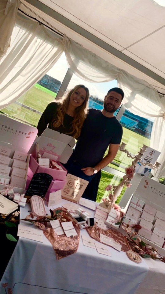 Couple at craft fair selling jewelry.