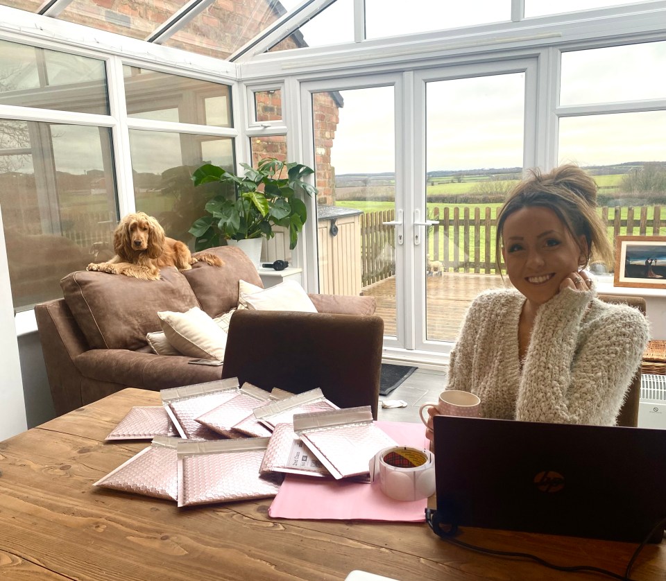 Woman working at home, packaging orders for her Etsy shop.