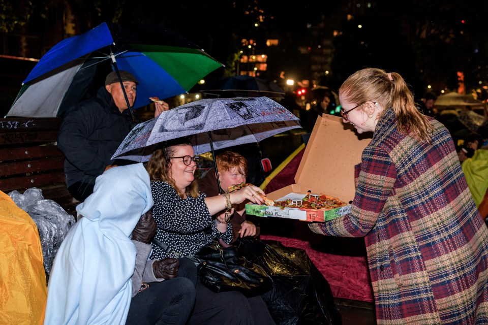Strangers shared food, umbrellas, and drinks in a show of unity
