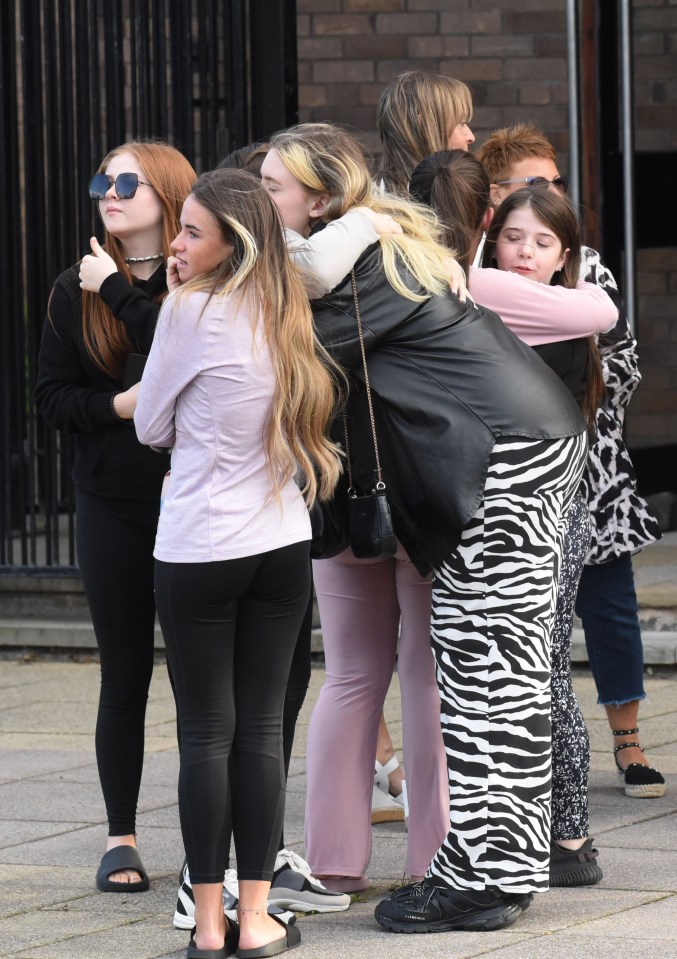 People hugged friends and family outside the church