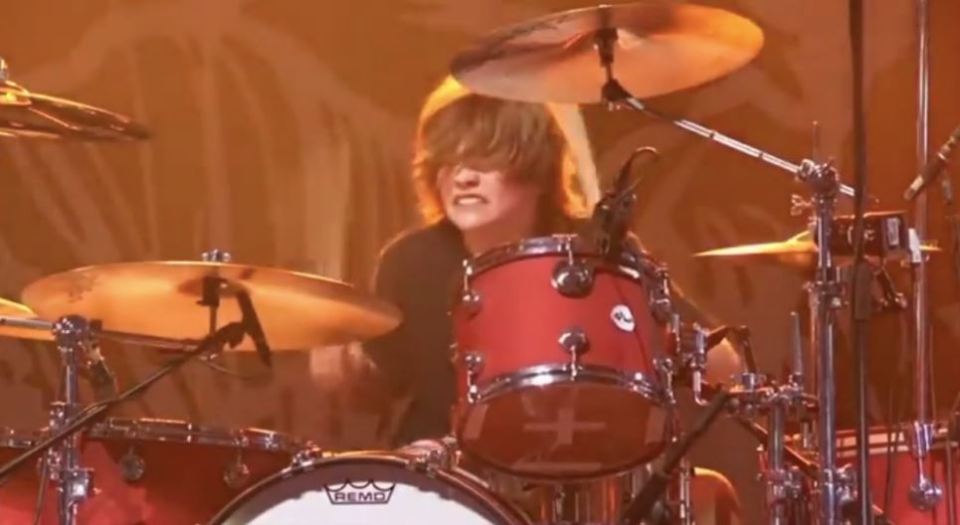 Oliver Shane Hawkins playing drums in tribute to his father.