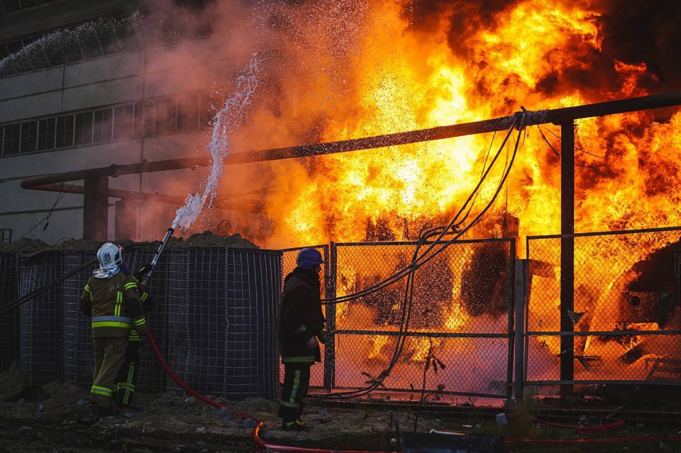 Firefighters battle a blaze at a power station after shelling in Kyiv