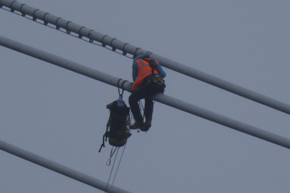 The group said the two nuts got up there by climbing masts on the North side of the bridge