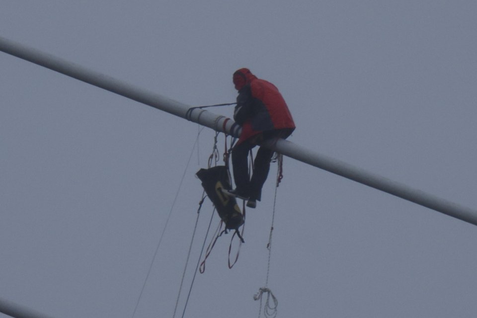 Protesters used ropes to haul themselves along the massive suspension wires