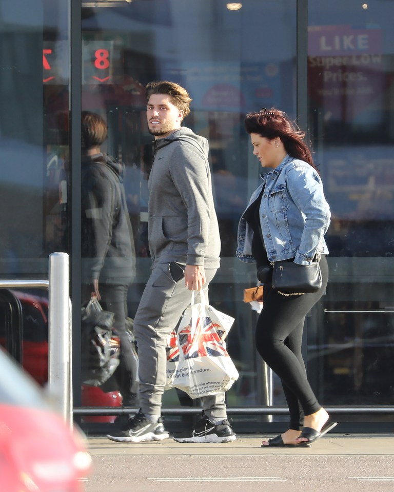 They were spotted carrying bags for live as they strolled around a retail park
