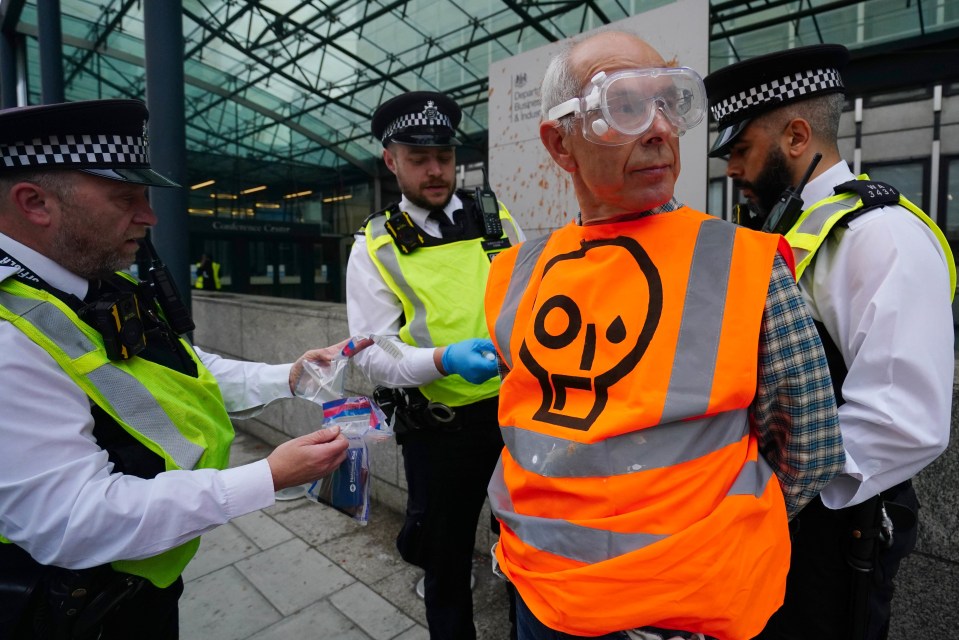 One nut activist is arrested as he dons goggles following a protest in Central London